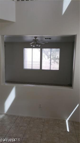 spare room featuring tile patterned floors and ceiling fan