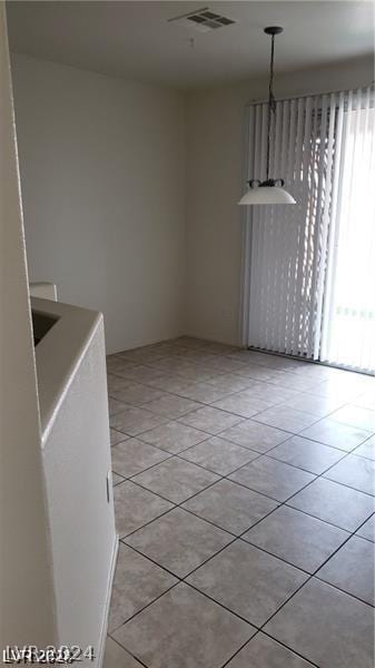 unfurnished dining area with light tile patterned floors