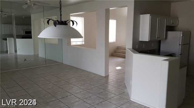 kitchen featuring light tile patterned floors and white fridge