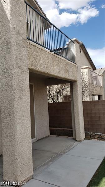 view of side of property featuring a balcony