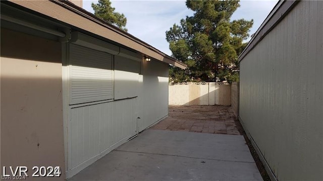 view of side of home with a patio area