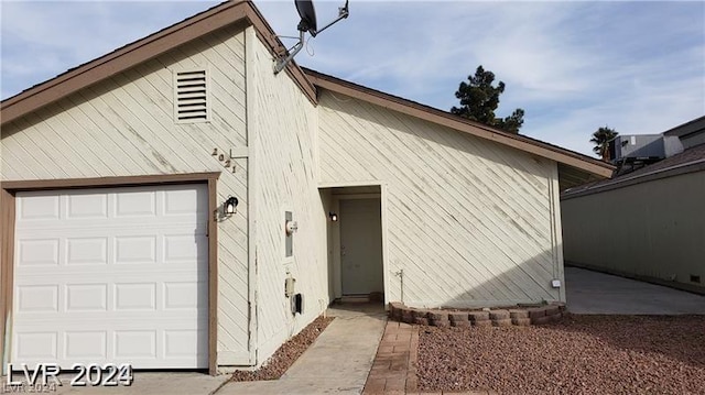 rear view of property featuring a garage