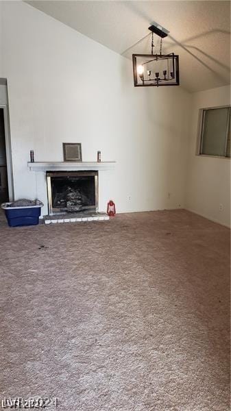 carpeted living room featuring vaulted ceiling