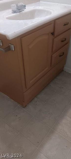 bathroom featuring tile patterned flooring and vanity