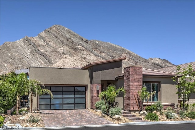 view of front of house with a garage and a mountain view