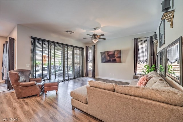 living room featuring hardwood / wood-style floors, a wealth of natural light, and ceiling fan