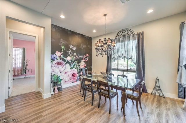 dining room featuring an inviting chandelier, plenty of natural light, and light hardwood / wood-style flooring