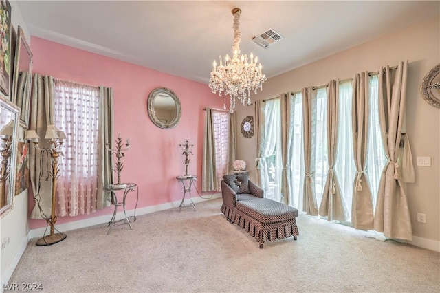 living area featuring a chandelier, light carpet, and a wealth of natural light