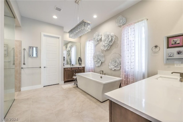 bathroom with vanity, tile patterned floors, and shower with separate bathtub