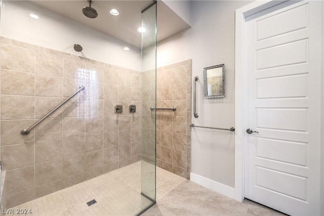 bathroom featuring tile patterned flooring and tiled shower