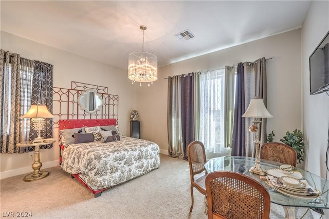 bedroom featuring a chandelier and carpet flooring