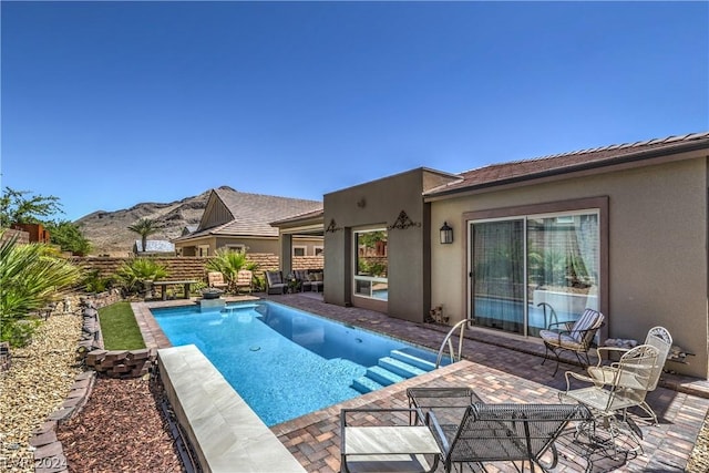 view of pool featuring a mountain view and a patio area