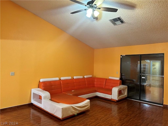 unfurnished room featuring hardwood / wood-style flooring, ceiling fan, vaulted ceiling, and a textured ceiling