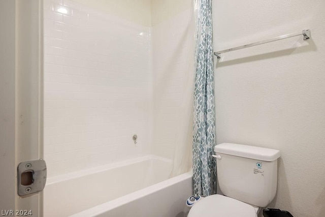 bathroom featuring shower / bathtub combination with curtain and toilet