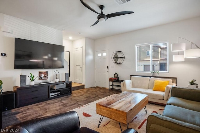 living room with ceiling fan and dark hardwood / wood-style flooring