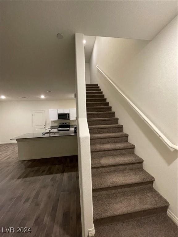 stairway featuring wood-type flooring