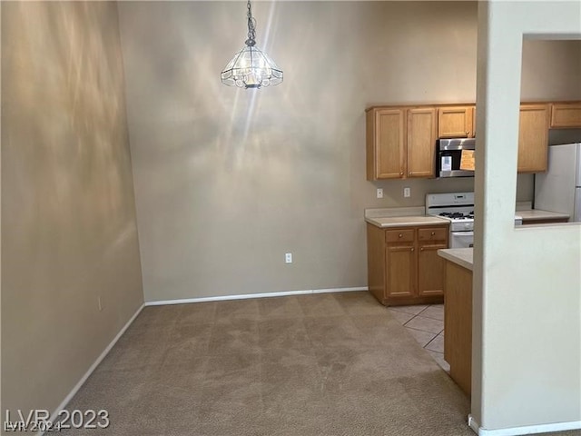 kitchen with light carpet, hanging light fixtures, stove, and white refrigerator