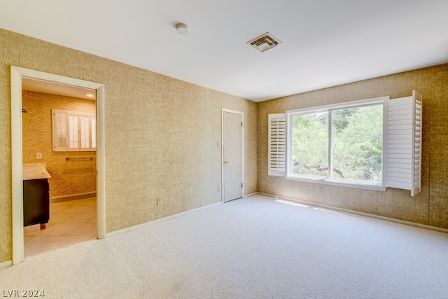 unfurnished bedroom with light colored carpet