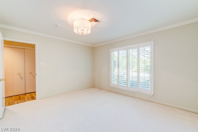 unfurnished room featuring carpet flooring and ornamental molding