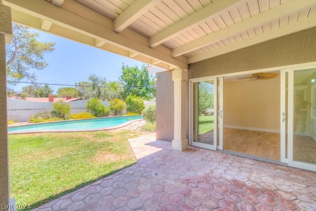 view of patio / terrace featuring ceiling fan and a fenced in pool