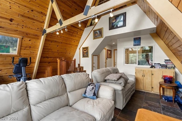 living room with wood ceiling, wood walls, and vaulted ceiling with beams