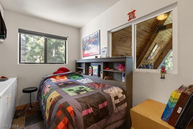 bedroom with beam ceiling, multiple windows, and wooden ceiling