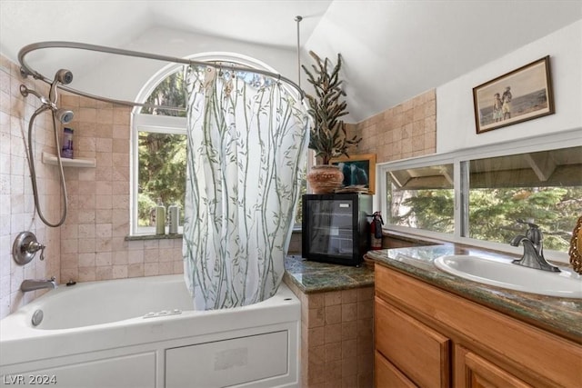 bathroom with shower / tub combo, vanity, and lofted ceiling