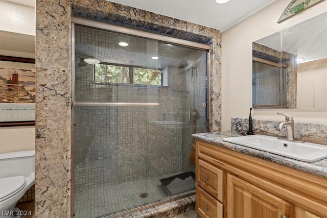 bathroom with vanity, an enclosed shower, and toilet