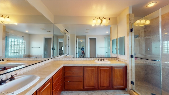 bathroom with an enclosed shower, vanity, and tile patterned floors