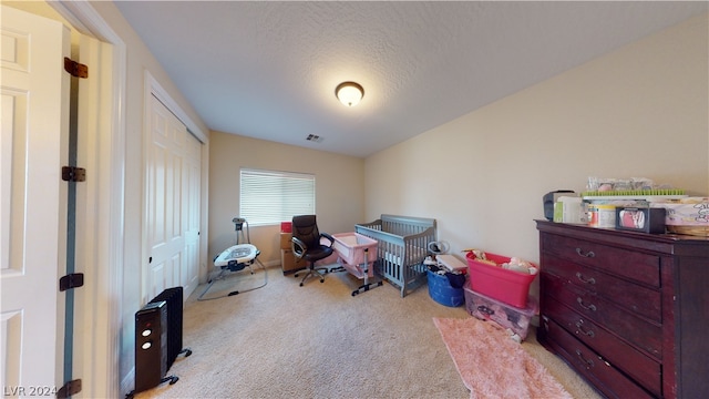 carpeted office with a textured ceiling