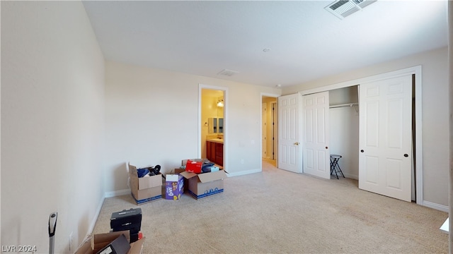 bedroom featuring light colored carpet and a closet