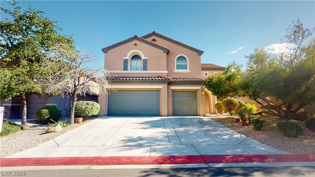 mediterranean / spanish-style house with a garage