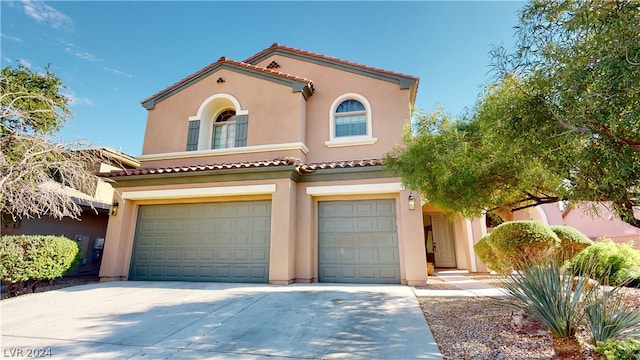 mediterranean / spanish-style house with a garage