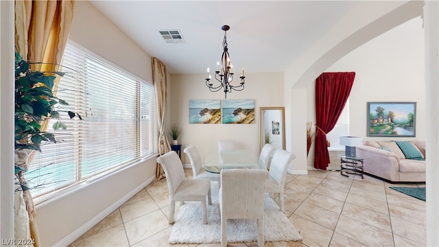 tiled dining space featuring a chandelier