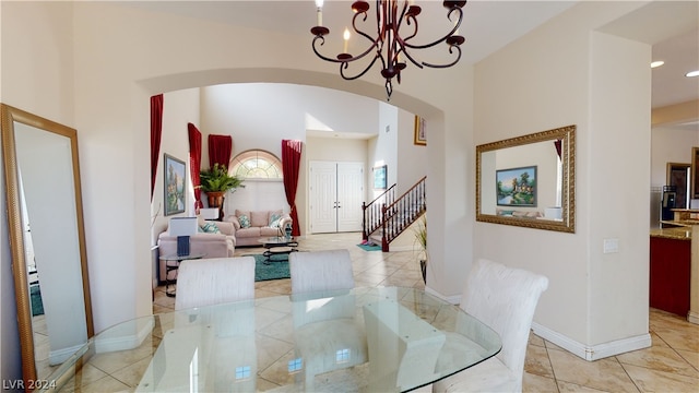 tiled dining area with a chandelier