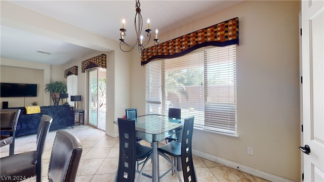 tiled dining room with a notable chandelier