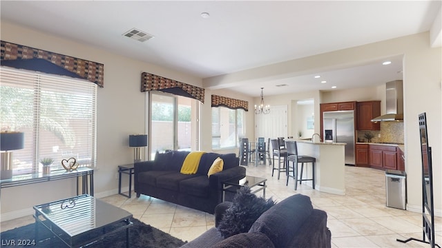 living room featuring a chandelier and light tile patterned floors