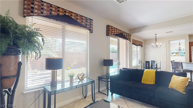 living room featuring light tile patterned floors and a chandelier