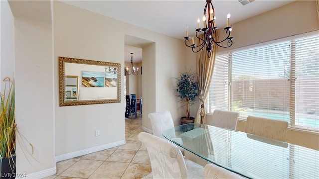 dining space featuring an inviting chandelier, a healthy amount of sunlight, and light tile patterned flooring