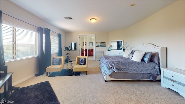 bedroom with light carpet and french doors