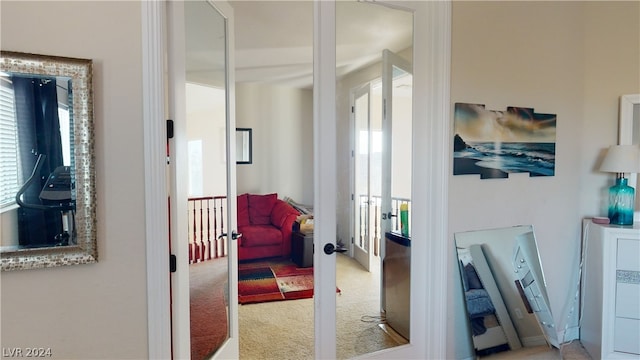 corridor featuring plenty of natural light, carpet flooring, and french doors