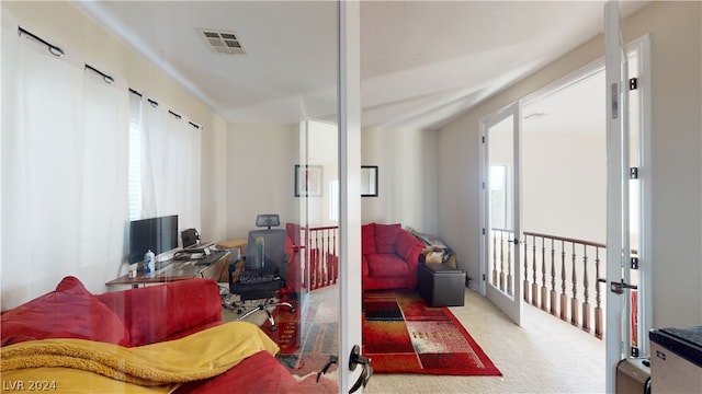 carpeted living room with a healthy amount of sunlight