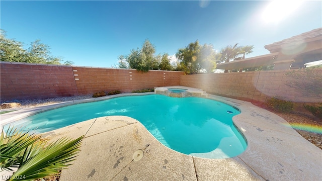 view of swimming pool featuring an in ground hot tub