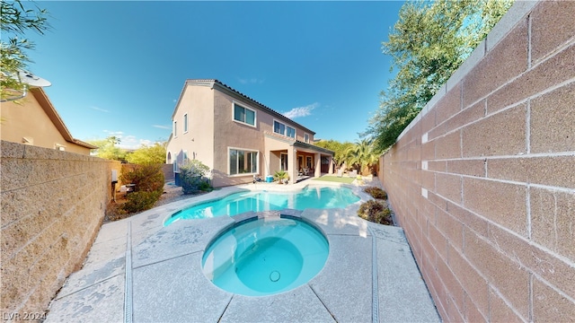 view of swimming pool featuring an in ground hot tub and a patio area