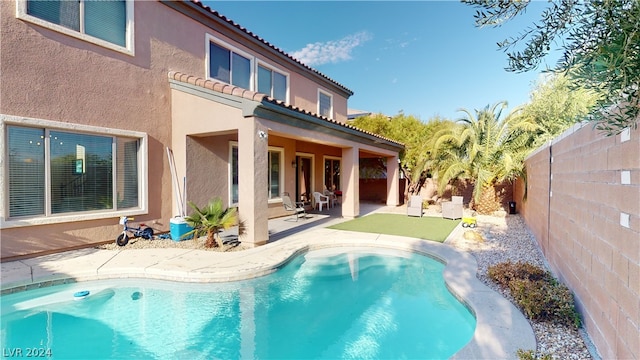 view of swimming pool with a patio