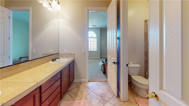 bathroom featuring vanity, tile patterned floors, and toilet