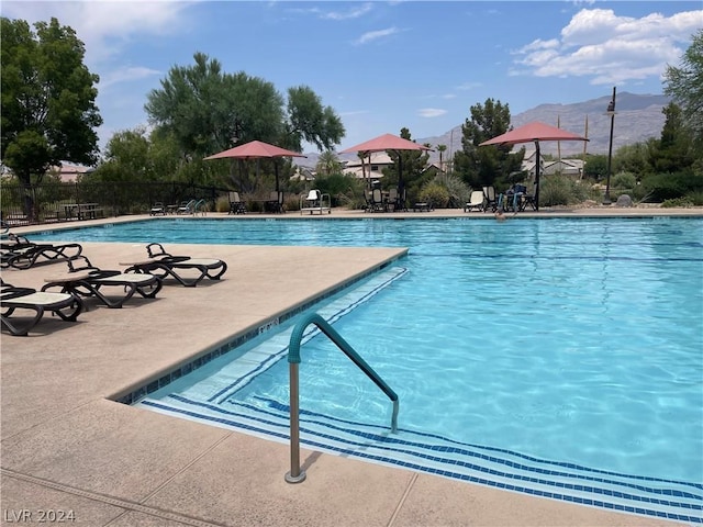 view of pool featuring a mountain view and a patio