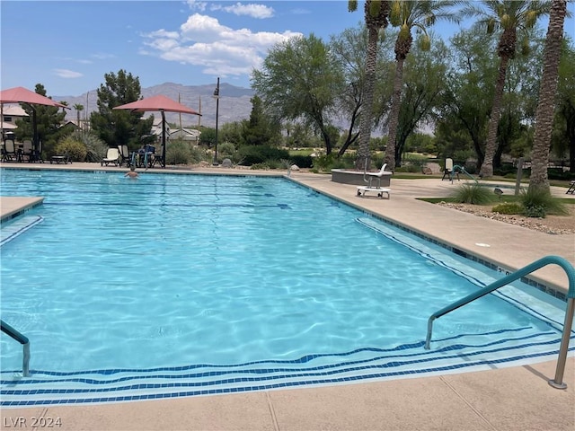 view of pool with a mountain view and a patio area