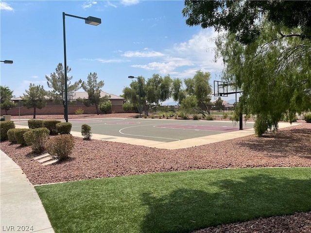 view of sport court featuring a lawn