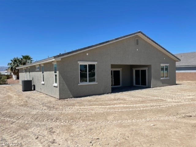 back of house featuring cooling unit